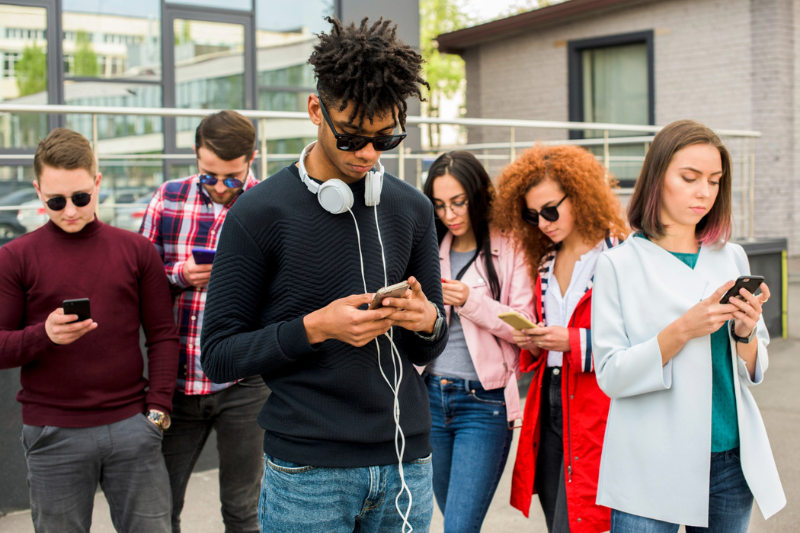 a group of young people using phones